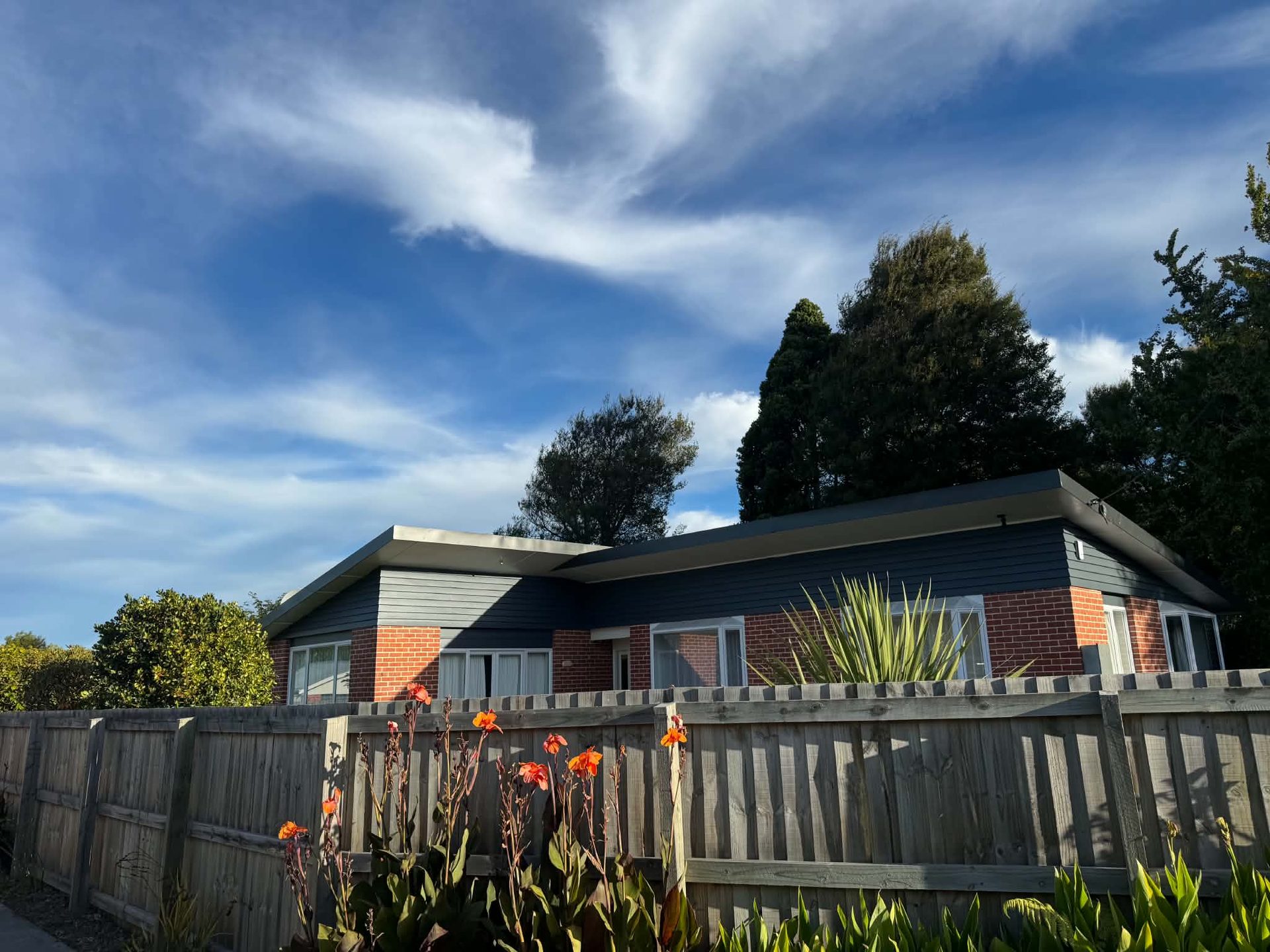 Repainted home exterior under blue sky