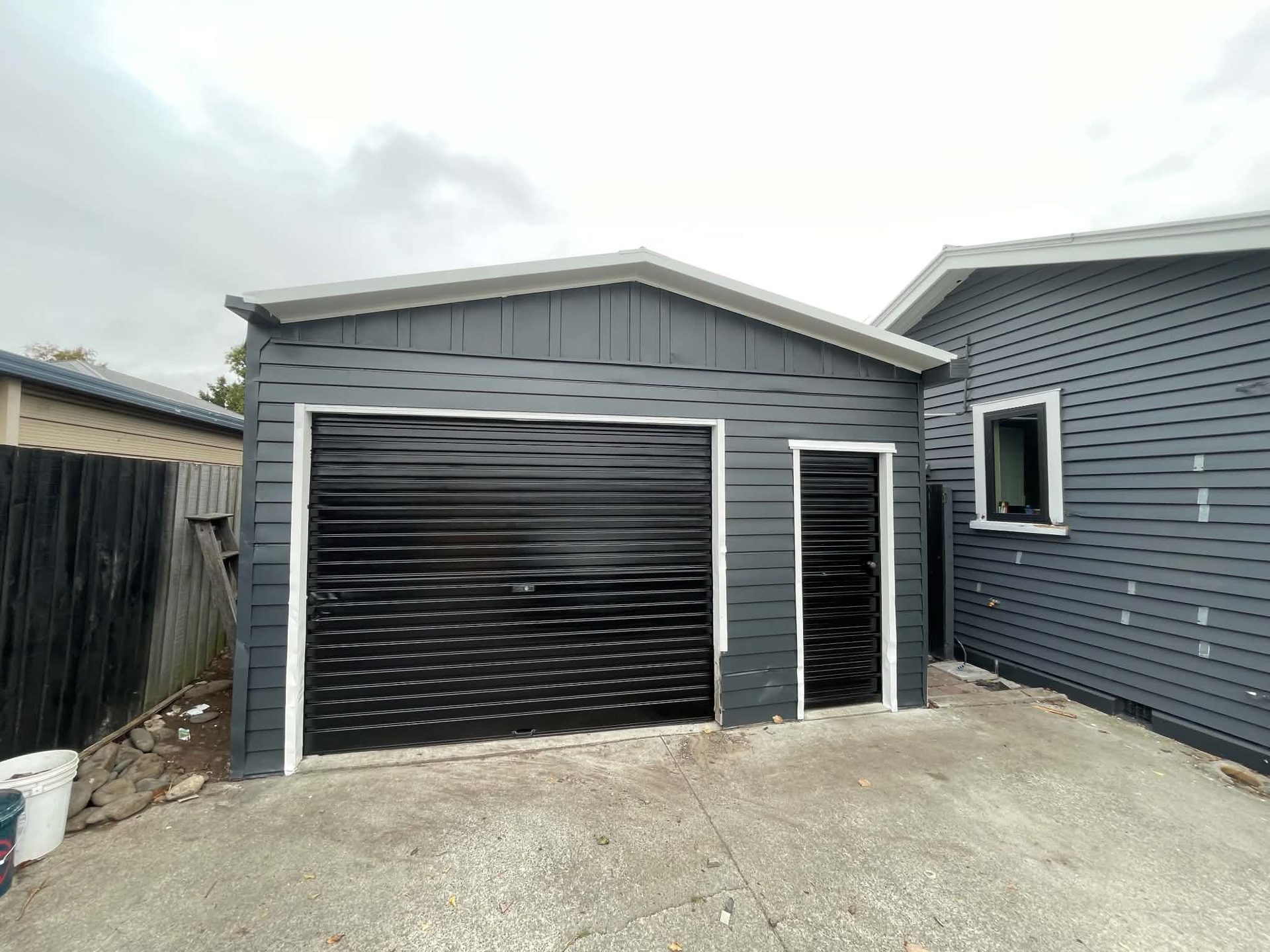 Grey garage doors and cladding on a modern home