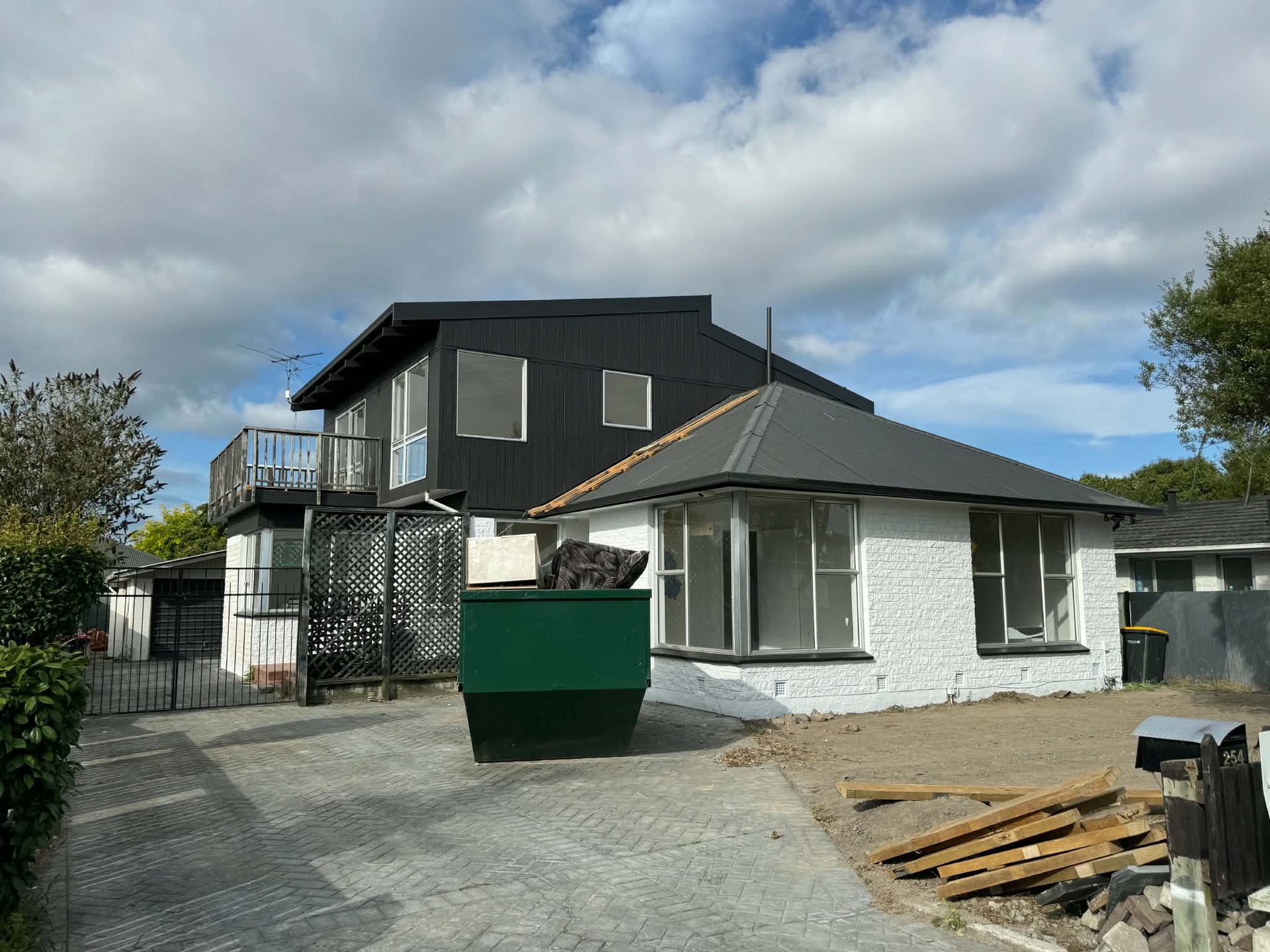 Two-storey repainted home exterior with driveway
