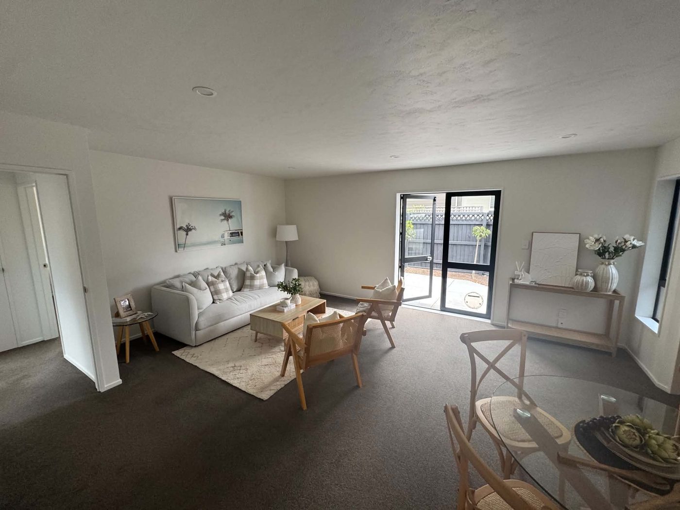 Freshly painted living room interior with light walls and grey carpet
