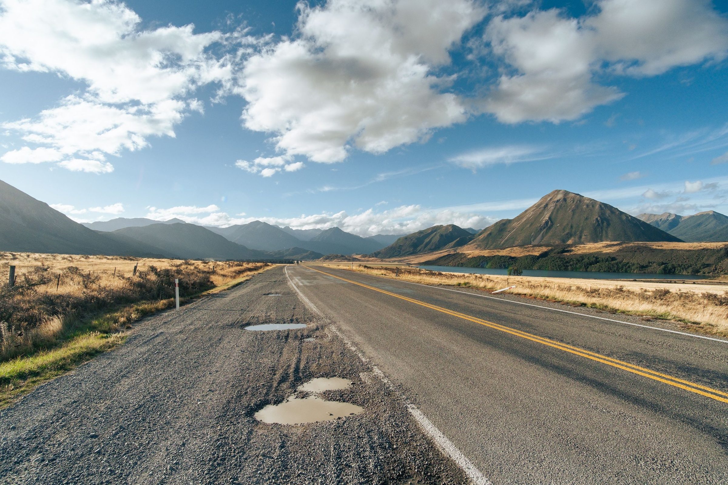 Mountain road near Lake Pearson in Canterbury with clear skies and rugged peaks