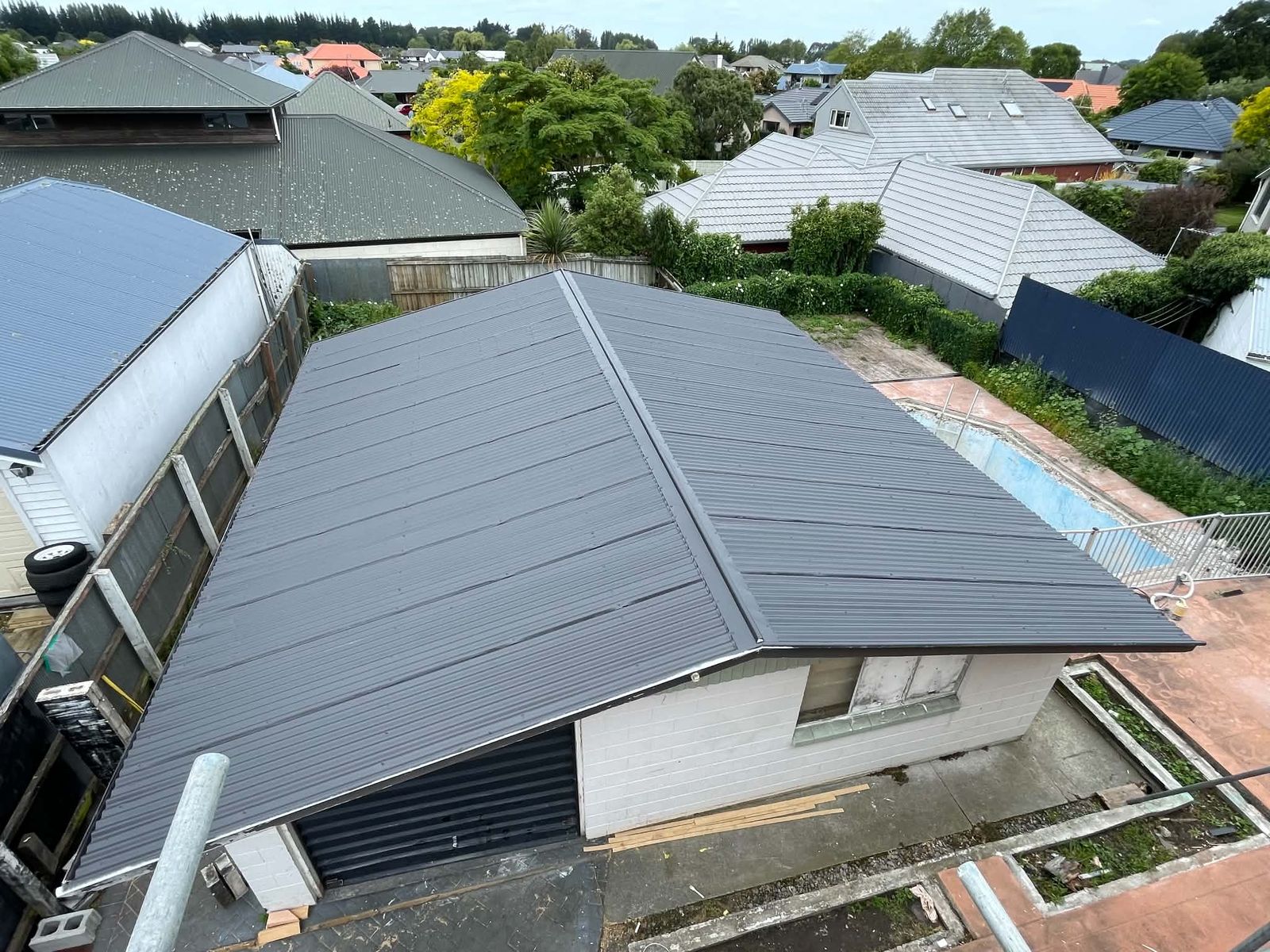 Freshly repainted corrugated roof in charcoal grey seen from above